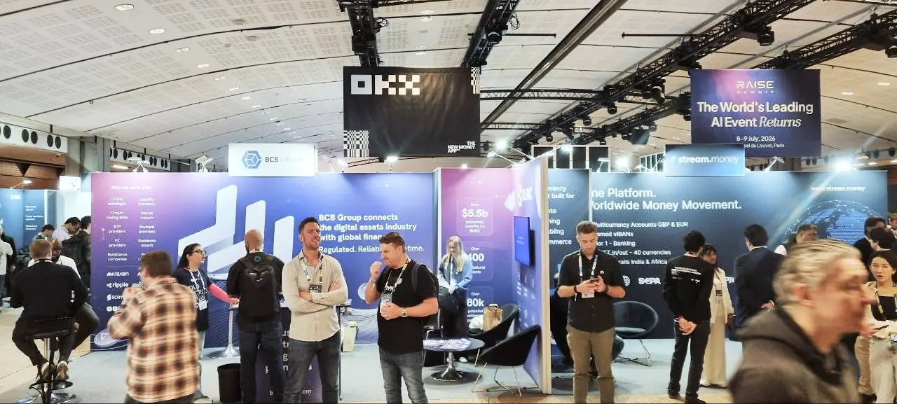 Exhibition booths at Paris Blockchain Week 2026, featuring corporate signage for BCB Group, OKX, and Stream.money.