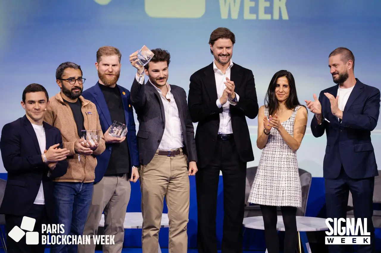 Manako winner of Start in Block 2026 at Paris Blockchain Week 2026, seven team members are present and one of them, Arno, is showing a trophy.